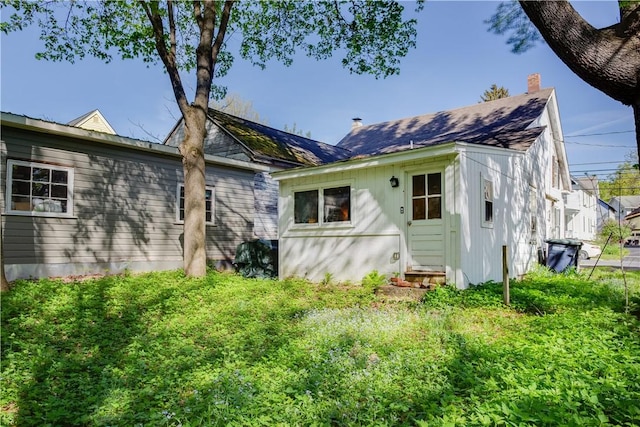 59 Elm St, Otsego, NY 13326 - rear view of house featuring a chimney