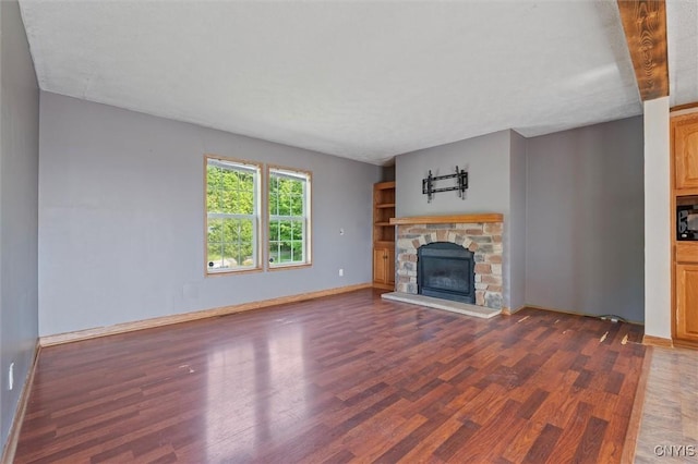 6669 Rottamore Rd, Stockbridge, NY 13409 - unfurnished living room featuring wood finished floors, a stone fireplace, and baseboards