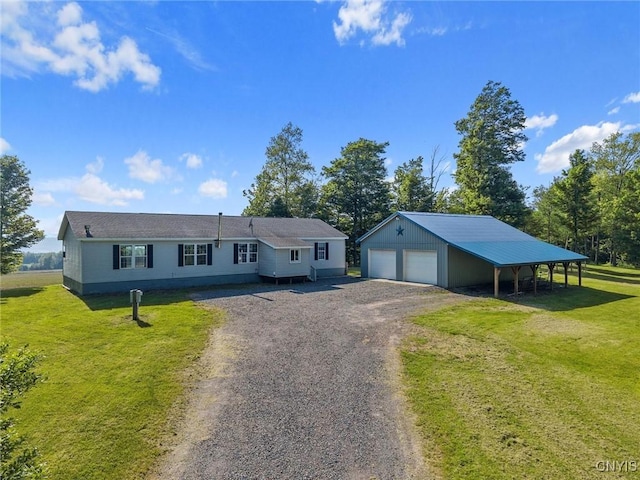 6669 Rottamore Rd, Stockbridge, NY 13409 - view of front facade with a garage, an outdoor structure, a front lawn, and driveway