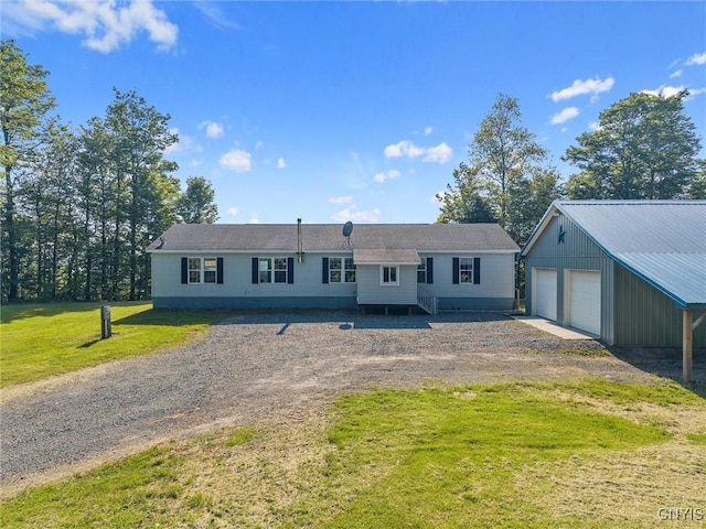 6669 Rottamore Rd, Stockbridge, NY 13409 - view of front of home featuring a garage, an outbuilding, a front lawn, and dirt driveway