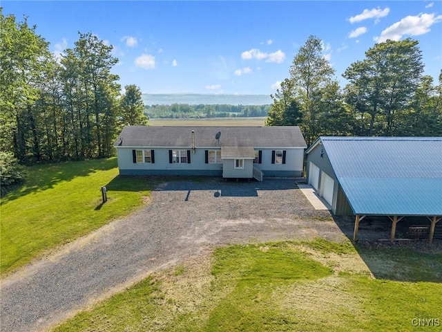 6669 Rottamore Rd, Stockbridge, NY 13409 - view of front facade with a front yard, a garage, and dirt driveway