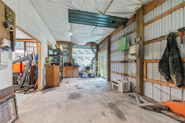 6669 Rottamore Rd, Stockbridge, NY 13409 - misc room with a garage, concrete flooring, and a wall mounted AC
