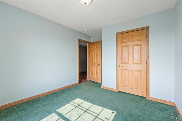 6669 Rottamore Rd, Stockbridge, NY 13409 - unfurnished bedroom featuring carpet floors and baseboards
