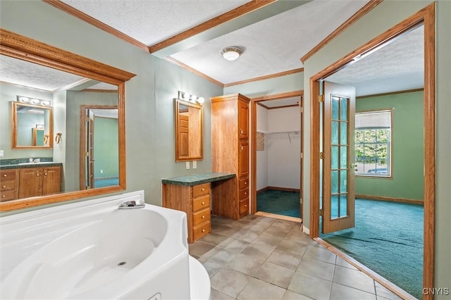 6669 Rottamore Rd, Stockbridge, NY 13409 - full bath with crown molding, vanity, a textured ceiling, a bath, and baseboards