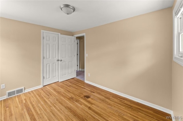 51 N Seine Dr Unit 1 & 2, Cheektowaga, NY 14227 - unfurnished bedroom featuring baseboards, light wood-style floors, and a closet