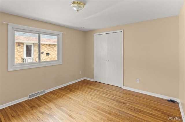 51 N Seine Dr Unit 1 & 2, Cheektowaga, NY 14227 - unfurnished bedroom featuring baseboards, light wood-style floors, and a closet