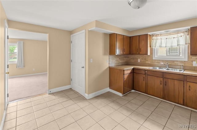 51 N Seine Dr Unit 1 & 2, Cheektowaga, NY 14227 - kitchen with a sink, light tile patterned floors, light countertops, baseboards, and brown cabinets