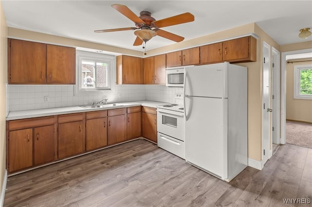 51 N Seine Dr Unit 1 & 2, Cheektowaga, NY 14227 - kitchen featuring white appliances, a sink, light countertops, and brown cabinets