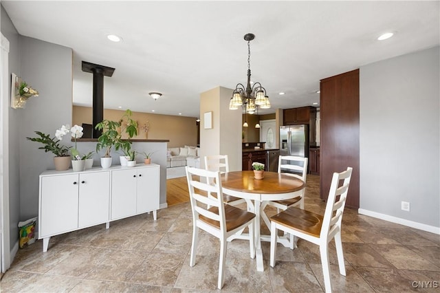 3477 Mcclary Rd, Lafayette, NY 13084 - dining room with a chandelier, baseboards, recessed lighting, a wood stove, and light stone finish floors