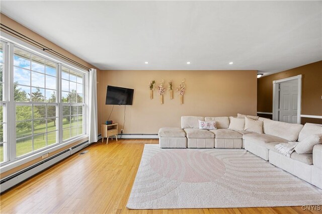 3477 Mcclary Rd, Lafayette, NY 13084 - living room featuring a baseboard heating unit, light wood finished floors, and recessed lighting