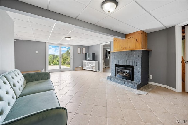 3477 Mcclary Rd, Lafayette, NY 13084 - living room with a drop ceiling, light tile patterned flooring, baseboards, and a fireplace