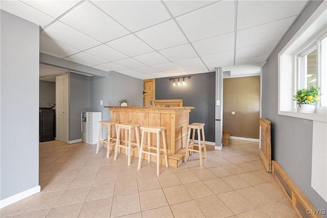 3477 Mcclary Rd, Lafayette, NY 13084 - indoor bar with a paneled ceiling, light tile patterned floors, and baseboards