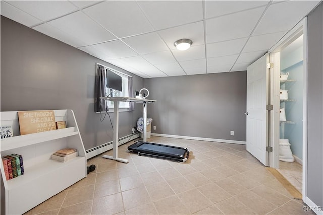 3477 Mcclary Rd, Lafayette, NY 13084 - exercise room featuring baseboard heating, a paneled ceiling, baseboards, and tile patterned floors
