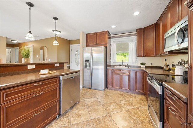 3477 Mcclary Rd, Lafayette, NY 13084 - kitchen with appliances with stainless steel finishes, pendant lighting, a sink, light tile patterned floors, and dark countertops