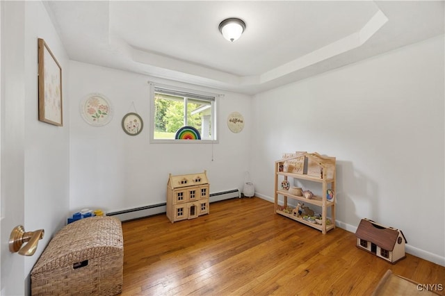 3477 Mcclary Rd, Lafayette, NY 13084 - misc room with baseboard heating, hardwood / wood-style flooring, and a tray ceiling