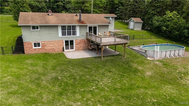 3477 Mcclary Rd, Lafayette, NY 13084 - rear view of property with a wooden deck, an outdoor pool, a patio area, a gate, and a chimney