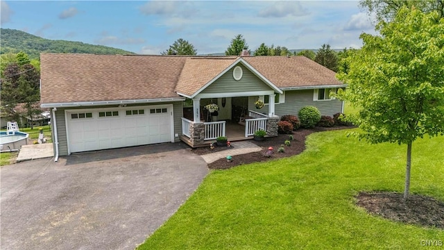 3477 Mcclary Rd, Lafayette, NY 13084 - ranch-style home with a porch, asphalt driveway, a garage, a front yard, and roof with shingles