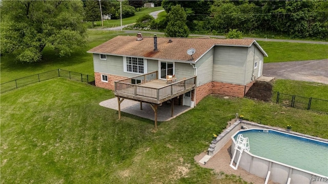3477 Mcclary Rd, Lafayette, NY 13084 - back of property featuring a deck, an outdoor pool, brick siding, and roof with shingles