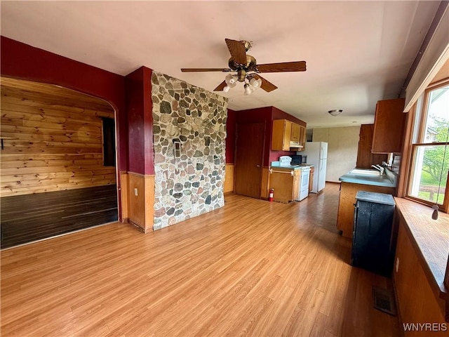 3394 Pike Rd, Alexander, NY 14020 - kitchen with a ceiling fan, white appliances, light wood-style flooring, a sink, and arched walkways