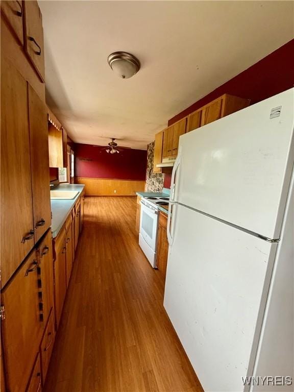 3394 Pike Rd, Alexander, NY 14020 - kitchen with white appliances, brown cabinetry, dark wood-type flooring, and a sink