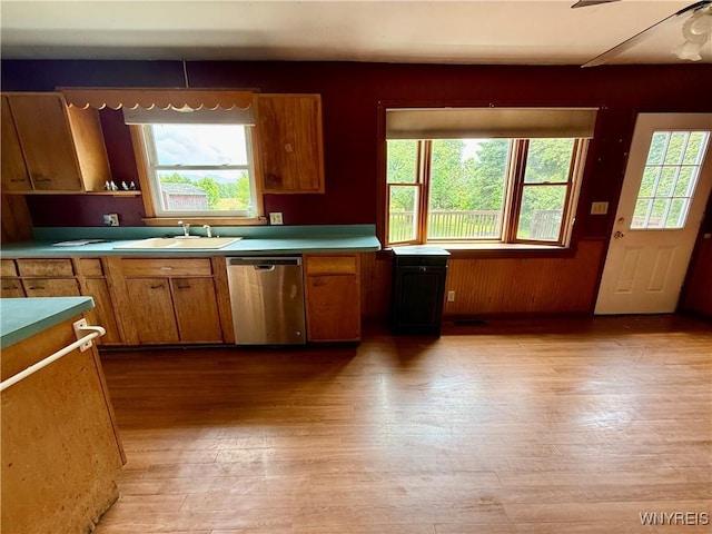 3394 Pike Rd, Alexander, NY 14020 - kitchen featuring dishwasher, a sink, brown cabinetry, light wood-type flooring, and ceiling fan