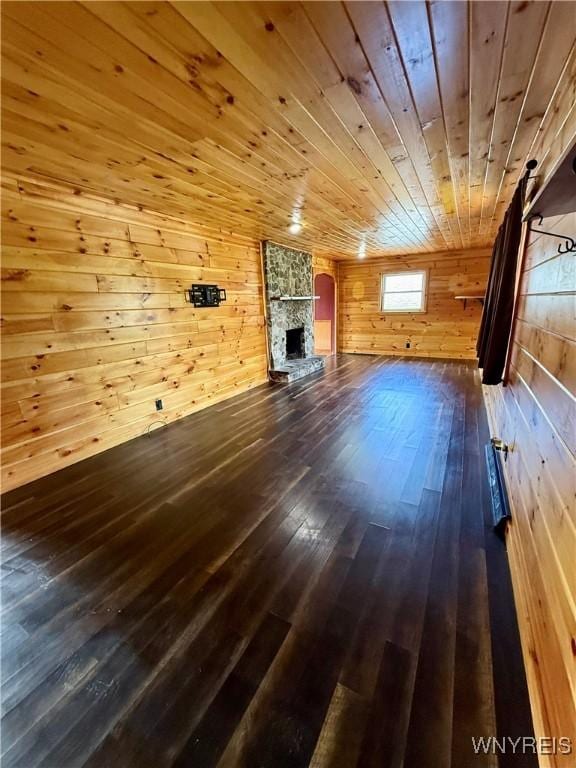 3394 Pike Rd, Alexander, NY 14020 - unfurnished living room with wood walls, wooden ceiling, hardwood / wood-style flooring, and a fireplace