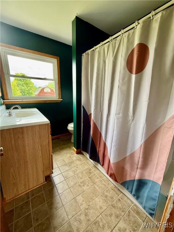 3394 Pike Rd, Alexander, NY 14020 - bathroom with vanity, toilet, and a shower with shower curtain