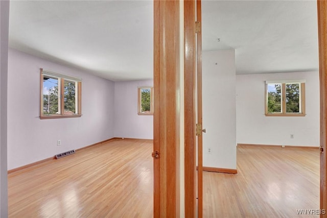 61 Caesar Blvd, Amherst, NY 14221 - unfurnished room with plenty of natural light, wood finished floors, and baseboards