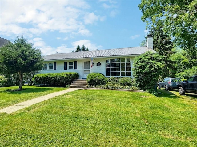 6251 Willard St, Aurelius, NY 13034 - ranch-style house featuring a front lawn, a chimney, and metal roof