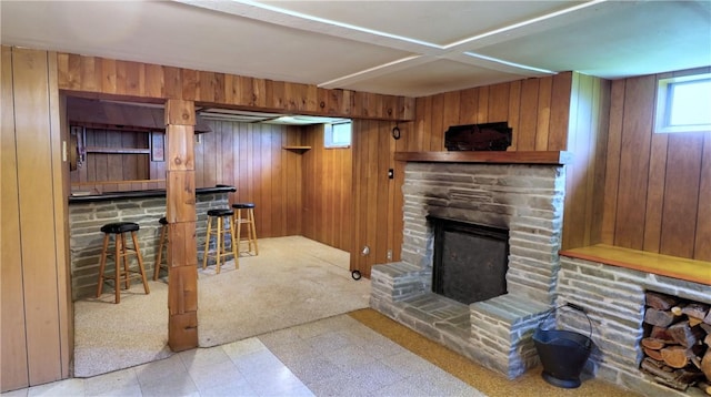 6251 Willard St, Aurelius, NY 13034 - living area featuring wood walls, a bar, tile patterned floors, and a stone fireplace