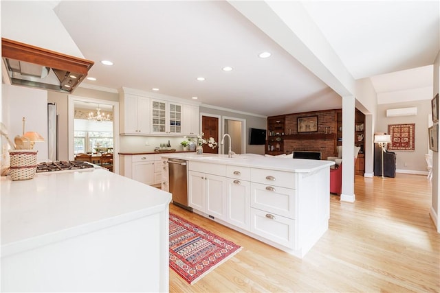 307 Allens Creek Rd, Brighton, NY 14618 - kitchen with a sink, appliances with stainless steel finishes, a wall mounted air conditioner, a chandelier, and glass insert cabinets