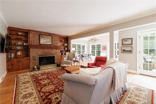 307 Allens Creek Rd, Brighton, NY 14618 - living area featuring a chandelier, crown molding, light wood-type flooring, healthy amount of natural light, and a brick fireplace