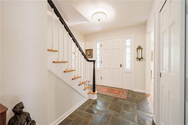 307 Allens Creek Rd, Brighton, NY 14618 - foyer featuring stone tile flooring, baseboards, and stairs