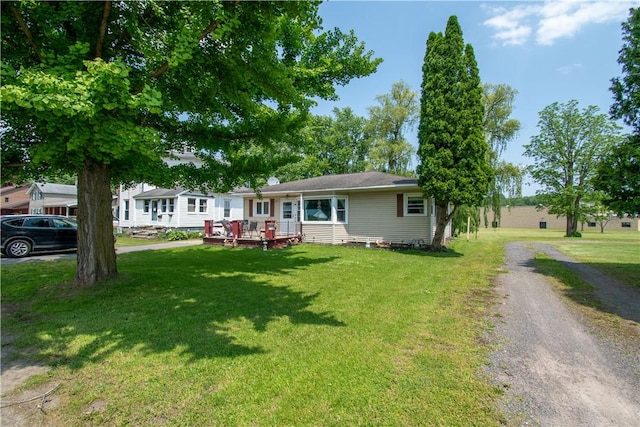 249 Glasgow St, Galen, NY 14433 - ranch-style house featuring a front yard, driveway, and a deck
