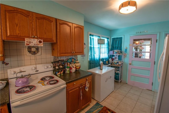 249 Glasgow St, Galen, NY 14433 - kitchen with white appliances, brown cabinets, healthy amount of natural light, and tasteful backsplash