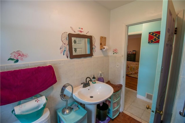 249 Glasgow St, Galen, NY 14433 - bathroom featuring tile walls, a sink, tile patterned flooring, and toilet