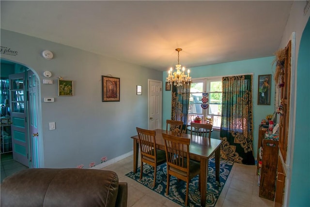 249 Glasgow St, Galen, NY 14433 - dining area with a chandelier, light tile patterned flooring, and arched walkways