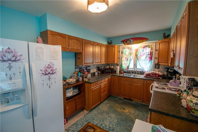 249 Glasgow St, Galen, NY 14433 - kitchen featuring white appliances, a sink, brown cabinetry, and dark countertops