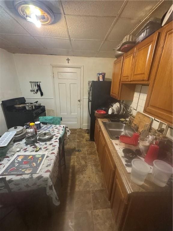 94 Lorimer St, Rochester, NY 14608 - kitchen with a sink, brown cabinets, and a drop ceiling