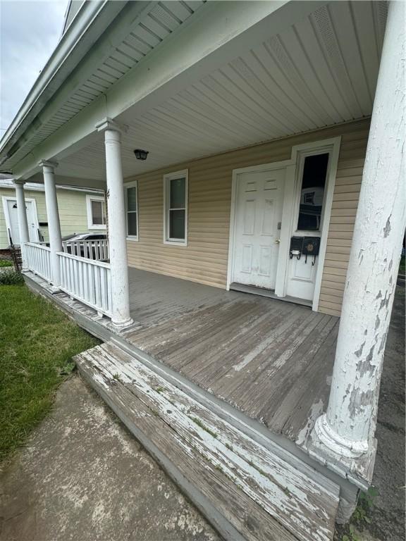94 Lorimer St, Rochester, NY 14608 - wooden porch with an attached carport