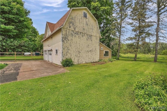 65 E Main St, Arcade, NY 14009 - view of side of home featuring a garage, driveway, and a lawn