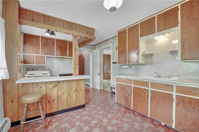 65 E Main St, Arcade, NY 14009 - kitchen with baseboard heating, white range oven, light countertops, and decorative backsplash
