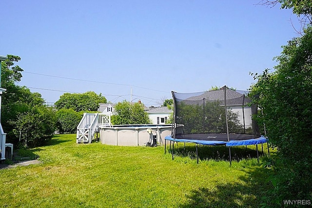 2927 S Ave, Niagara Falls, NY 14305 - view of grassy yard with a trampoline and an outdoor pool