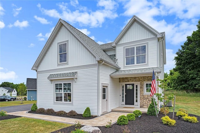 96 Chase Meadow Trl, Mendon, NY 14472 - view of front of home featuring board and batten siding, a shingled roof, and stone siding