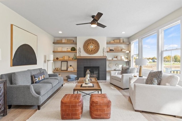 96 Chase Meadow Trl, Mendon, NY 14472 - living room featuring light wood finished floors, ceiling fan, a tile fireplace, and recessed lighting