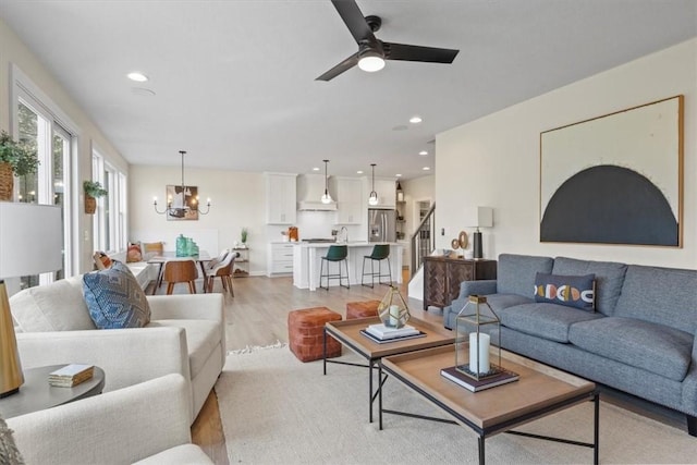96 Chase Meadow Trl, Mendon, NY 14472 - living area featuring a chandelier, light wood-style floors, stairs, a ceiling fan, and recessed lighting