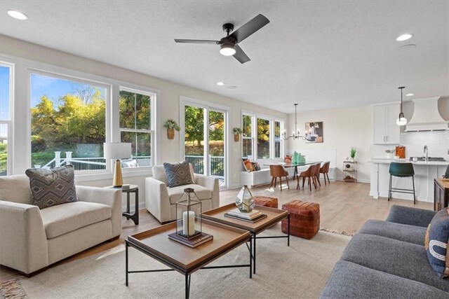 96 Chase Meadow Trl, Mendon, NY 14472 - living room with a chandelier, a ceiling fan, light wood-type flooring, and recessed lighting