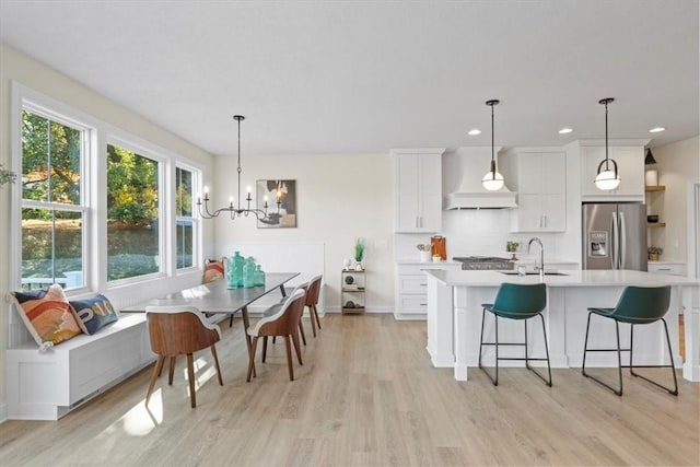 96 Chase Meadow Trl, Mendon, NY 14472 - kitchen featuring stainless steel appliances, custom range hood, a sink, light countertops, and plenty of natural light