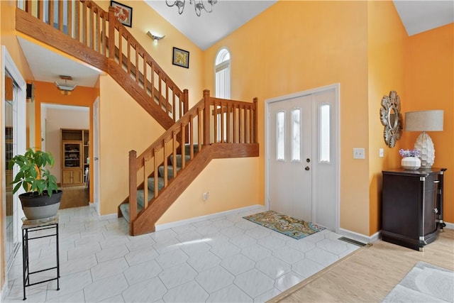 106 Shingle Landing Dr, Irondequoit, NY 14609 - entryway with plenty of natural light, high vaulted ceiling, stairs, and baseboards