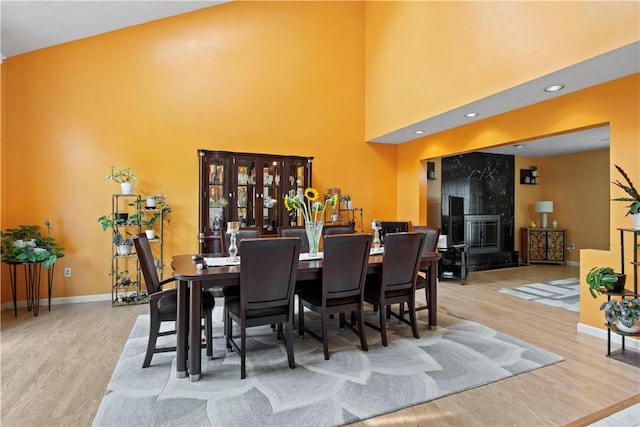 106 Shingle Landing Dr, Irondequoit, NY 14609 - dining room with wood finished floors, baseboards, and a towering ceiling